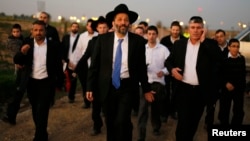 Aryeh Deri (C), leader of the ultra-Orthodox Shas party, attends an annual pilgrimage to the gravesite of Rabbi Yisrael Abuhatzeira, in the southern town of Netivot, Jan. 14, 2013.