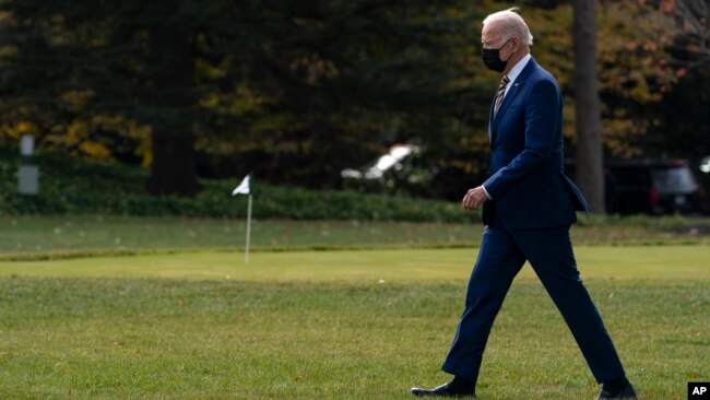 President Joe Biden walks to board Marine One on the South Lawn of the White House for a trip to Minnesota to promote his infrastructure plan, in Washington, Nov. 30, 2021.