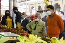 Residents wearing face masks shop for the Ramadan in Tunis, Thursday, April 23, 2020.