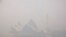 FILE - A sailing boat passes the Sydney Opera House as smoke from bushfires blankets the city. 