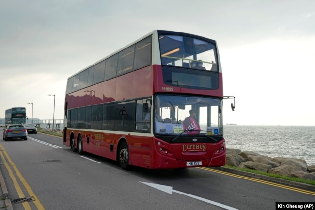 Sebuah bus tingkat melintas di jalan tepi laut dekat bandara di Hong Kong, Sabtu, 16 Oktober 2021. Perjalanan sejauh 47 mil, lima jam dengan bus tingkat di sekitar wilayah itu dimaksudkan untuk menarik orang-orang yang mudah tidur dalam perjalanan panjang