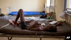 FILE- A child suffering from Ebola receives treatment at Makeni Arab Holding Center in Makeni, Sierra Leone, Oct. 4, 2014.