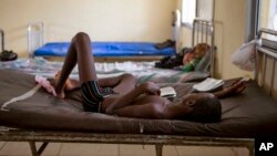 FILE- A child suffering from the Ebola virus receives treatment at Makeni Arab Holding Center in Makeni, Sierra Leone, Oct. 4, 2014.