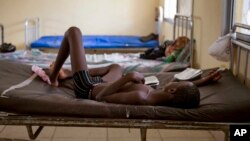 FILE- A child suffering from the Ebola virus receives treatment at Makeni Arab Holding Center in Makeni, Sierra Leone, Oct. 4, 2014.