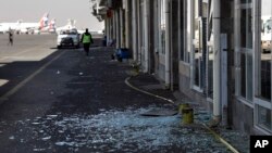 Workers walk past broken glass in Sanaa International Airport following Thursday's Israeli airstrikes on Yemen, Dec. 27, 2024. 