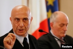 Italian Interior Minister Marco Minniti, left, and Police Chief Franco Gabrielli attend a news conference in Rome, Italy, to announce that the suspect in the Berlin truck attack had been killed in a shootout in a suburb of the northern Italian city of Milan, Dec. 23, 2016.