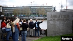 FILE— Students attend a guided tour with Pierre Guillon de Prince and Dieudonne Boutrin at the Memorial to the Abolition of Slavery in Nantes, France, March 23, 2024.