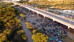 Migrants, many from Haiti, are seen in an encampment along the Del Rio International Bridge near the Rio Grande, Sept. 23, 2021, in Del Rio, Texas.