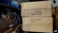 FILE - Packages labeled "Made in China" are loaded on a UPS truck for delivery in New York.