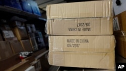 FILE - Packages labeled "Made in China" are loaded on a UPS truck for delivery in New York.