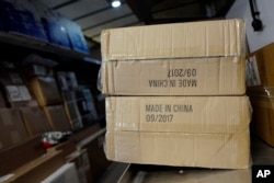 FILE - Packages labeled "Made in China" are loaded on a UPS truck for delivery in New York.