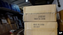 FILE - Packages labeled "Made in China" are loaded on a UPS truck for delivery in New York, May 9, 2017.