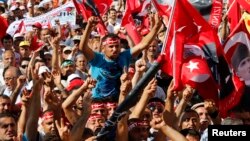 Anti-government protesters shout slogans during a demonstration in Istanbul, Turkey, June 23, 2013. 
