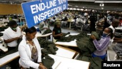 FILE - Kenyan workers prepare clothes for export at the Alltex export processing zone factory in Athi River, near Nairobi.