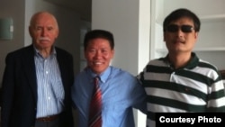 Bob Fu (center) helped Chinese dissident Chen Guangcheng (right) come to the United States. 