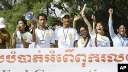 Cambodian non-governmental organizations workers shout slogans during a demonstration in Phnom Penh, Cambodia, 2004. Local aid workers marched through Phnom Penh to urge the donors to press Cambodia to remove restrictions on demonstrations, promote rule o