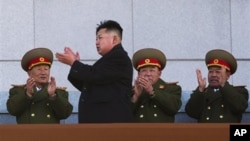 New North Korean leader Kim Jong Un, second from left, applauds as he leaves the stands at Kumsusan Memorial Palace in Pyongyang, Feb. 16, 2012.