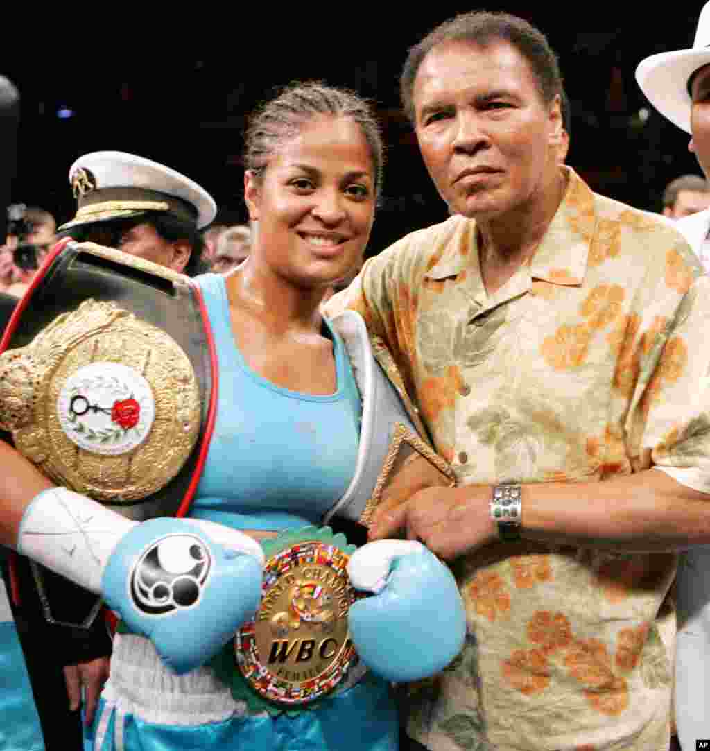 FILE - Laila Ali, left, poses with her father, boxing great Muhammad Ali, after her win against Erin Toughill at the MCI Center in Washington, June 11, 2005.