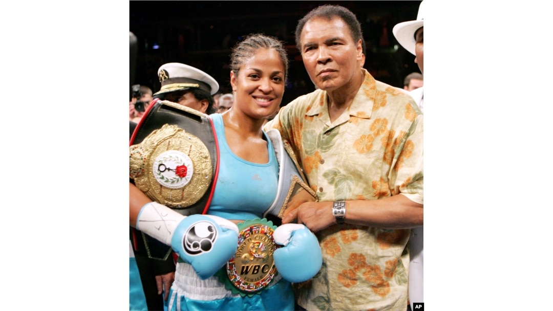 FILE - Laila Ali, left, poses with her father, boxing great Muhammad Ali, after her win against Erin Toughill at the MCI Center in Washington, June 11, 2005.