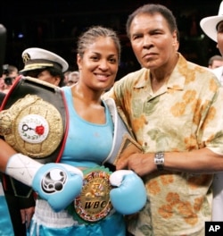 FILE - Laila Ali, left, poses with her father, boxing great Muhammad Ali, after her win against Erin Toughill at the MCI Center in Washington, June 11, 2005.