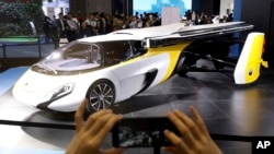 A visitor takes a photo of the Aeromobil, a flying car from Slovakia, during the China International Import Expo in Shanghai, Nov. 5, 2018.