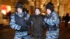 FILE - Police officers detain a protester during an unsanctioned protest in Moscow, Russia, Dec. 30, 2014.