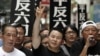 FILE - Xiong Yan flashes a victory sign during a march in Hong Kong marking the 20th anniversary of the military crackdown on a pro-democracy student movement in Beijing, May 31, 2009. 