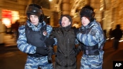 FILE - Police officers detain a protester during an unsanctioned protest in Moscow, Russia, Dec. 30, 2014.