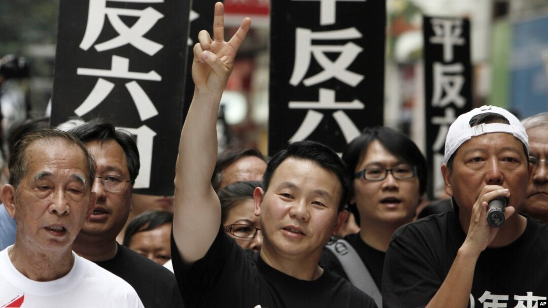 FILE - Xiong Yan flashes a victory sign during a march in Hong Kong marking the 20th anniversary of the military crackdown on a pro-democracy student movement in Beijing, May 31, 2009. 
