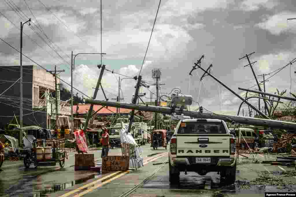 Fallen electric pylons block a road in Surigao City, Surigao del norte province, days after super Typhoon Rai devastated the city.