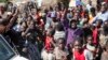 Internally displaced people celebrate during a distribution of tarps in Mubimbi, South Kivu, Democratic Republic of Congo, March 4, 2013.