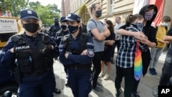 People hold a protest rally in front of Poland's Education Ministry in Warsaw, Poland, Oct. 4, 2020, against the appointment of a new education minister Przemyslaw Czarnek.