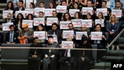 Activists and the leader of the Anerkennung Jetzt (Recognition Now) civil society initiative, Ilias Uyar (bottom, 2nd R), react after German lawmakers voted to recognize the Armenian genocide after a debate in the Bundestag, in Berlin, June 2, 2016.