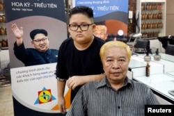 To Gia Huy, 9, and Le Phuc Hai, 66, pose after having their haircut in North Korean leader Kim Jong Un and U.S. President Donald Trump styles in a haircut salon in Hanoi, Vietnam February 19, 2019.