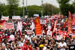 Protesters hold banners during a May Day protest in Ankara, Turkey, May 1, 2017. Workers and activists marked May Day with defiant rallies and marches.