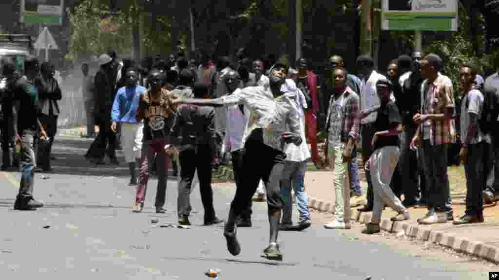 University students throw stones at police during a demonstration in Nairobi,Kenya, Tuesday, Sept, 22, 2015