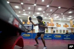 Shane Olff plays table tennis at a ping pong center in Beijing, June 13, 2016. "Ping pong brought me to China," says Olff, who says he only knew only a handful of Chinese words when he arrived.