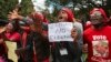 FILE - Opposition supporters march on the streets of Harare, Zimbabwe, June, 5, 2018.