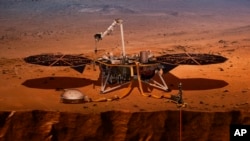 This illustration made available by NASA in 2018 shows the InSight lander drilling into Mars.