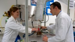 ESA research fellow Alexandre Meurisse and Beth Lomax of the University of Glasgow prepare to make oxygen and metal out of simulated moon dust inside ESA's Materials and Electrical Components Laboratory. (ESA/A. Conigili)
