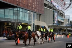 Vancouver police officers patrol the area with friendship bracelets adorned around their horses before Taylor Swift's "The Eras Tour," Dec. 6, 2024, in Vancouver, British Columbia.