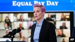 FILE - United States Soccer Women's National Team member Megan Rapinoe speaks during an event to mark Equal Pay Day in the South Court Auditorium in the Eisenhower Executive Office Building on the White House Campus, March 24, 2021.