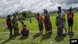 Hindu residents react in grief when shown the bodies of their dead family members in Maungdaw township last September