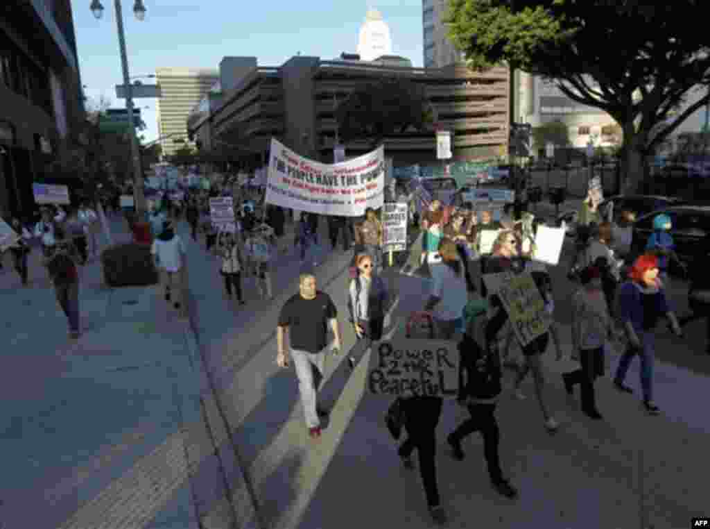 Anti-Wall Street demonstrators march in downtown Los Angeles, Monday, Oct. 3, 2011. The demonstrators entering their third day of a campout protest at Los Angeles City Hall said Monday they're planning to continue their action as long as it takes to buil