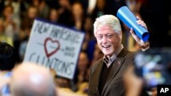 Former President Bill Clinton waves to a cheering crowd as he arrives during a campaign stop for his wife, Democratic presidential candidate Hillary Clinton, Jan. 4, 2016, in Nashua, N.H. 