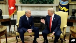 New White House Chief of Staff John Kelly talks with President Donald Trump after being privately sworn in during a ceremony in the Oval Office, July 31, 2017, in Washington. 