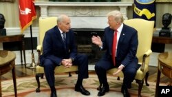 New White House Chief of Staff John Kelly talks with President Donald Trump after being privately sworn in during a ceremony in the Oval Office, July 31, 2017, in Washington. 