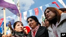 FILE - Figen Yuksekdag, center, co-chairwoman of the pro-Kurdish Peoples' Democratic Party (HDP) , participates in an attempted march that was dispersed by police in Istanbul.