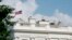 The American flag files at half-staff at the White House, Monday afternoon, Aug. 27, 2018, in Washington.