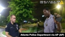 Picha hii iliyotolewa na Idara ya Polisi ya Atlanta inamuonyesha Rayshard Brooks akiongea na Afisa Garrett Rolfe kwenye eneo la kuengesha magari la mgahawa wa Wendy's, Jioni Ijumaa, Juni 12, 2020, mjini Atlanta. (Atlanta Police Department via AP)